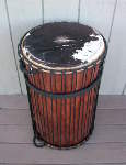 A dundunba that needs one of its cow skin drum heads replaced.