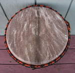 Djembe from Mali, Africa with a ripped drum head.