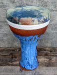 A ceramic doumbek drum with a tie dyed skin newly mounted.