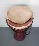 African Djembe hand drum with torn goatskin head.