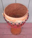 African djembe with a torn drum head.