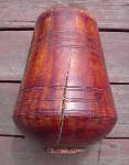 A long, deep crack on the shell of a tabla dayan.