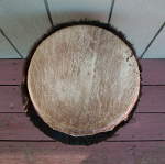 Torn drum head on an African djembe hand drum.
