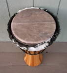 Stave djembe hand drum with a fresh drum head folded over.