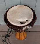 Torn goatskin drum head with hair on sides.