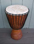 A djembe hand drum with a fresh African goat skin drum head.