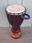Fresh African goat skin and new rope on a djembe hand drum.