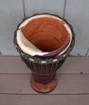 Djembe hand drum that's had its skin cut with a knife.