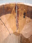 A look from the inside at a large crack on the shell of an African djembe hand drum.