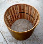 Slats added as reinforcement to the inside of an antique bass drum shell.
