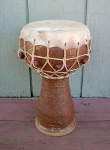 A clay doumbek hand drum with a split head.