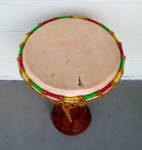 A djembe with a torn drum head.