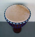 An African djembe hand drum with a fresh elk skin drum head and new rope.
