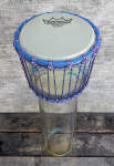 A small djembe with a glass shell.