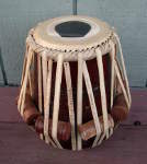 Tabla dayan with a torn drum head.