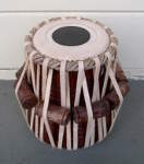 A tabla dahina with a brand new drum head and lacing.