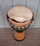 African djembe hand drum with a torn drum head.