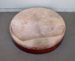 A ripped goat skin drum head on a bodhran frame drum.