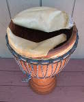 African djembe hand drum with a torn drum head.