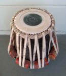 Tabla dayan with a damaged drumhead.