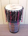 An ashiko hand drum with a broken drum head.