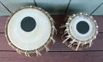 A tabla set with new pudis and strap.