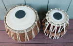 A tabla dayan and tabla bayan with a new tasma and fresh drum heads.