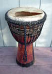 African djembe with a ripped drum head.