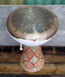Sombati drum with fishskin drumhead tearing from its skirt.