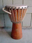 Djembe from Gambia, Africa with a ripped drum head.