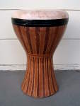 A reskinned clay doumbek with faux wood decorated shell.