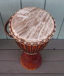 A fresh goat skin drum head and new rope on a djembe.