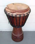 African djembe hand drum in need of new skin and rope.