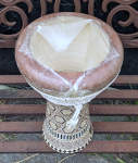 A Middle Eastern clay darbuka with a damaged drum head.
