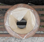A torn fish skin drum head on a ceramic doumbek.