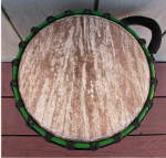 Stave djembe with a fresh goat skin drum head.