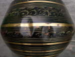 Large dents on the shell of a tabla bayan.
