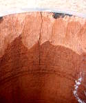Hairline crack on the shell of a tabla dayan.