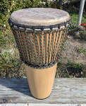 A beautiful ashiko drum with rasta colored rope.