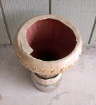 A clay doumbek hand drum with a ripped out drum head.