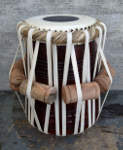 A new drum head and lacing on a tabla daya.