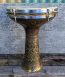 Newly repaired darbuka with a restored shell and new skin.