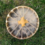 The underside of a shaman drum with new lacing and skin.
