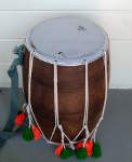 Drumhead on a dhol with a hole.