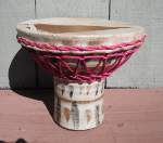 Ceramic doumbek with damaged drum head.
