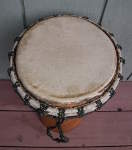 African jembe drum with a ripped drum head.