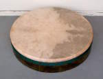 A bodhran drum with a punctured skin.