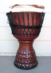African jembe drum in need of a drum head replacement.