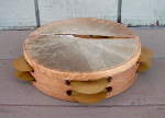 An Arabic tambourine with a ripped fish skin drum head.