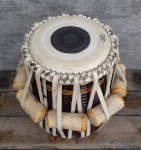 Reassembled tabla dayan that had large splits in the shell repaired.